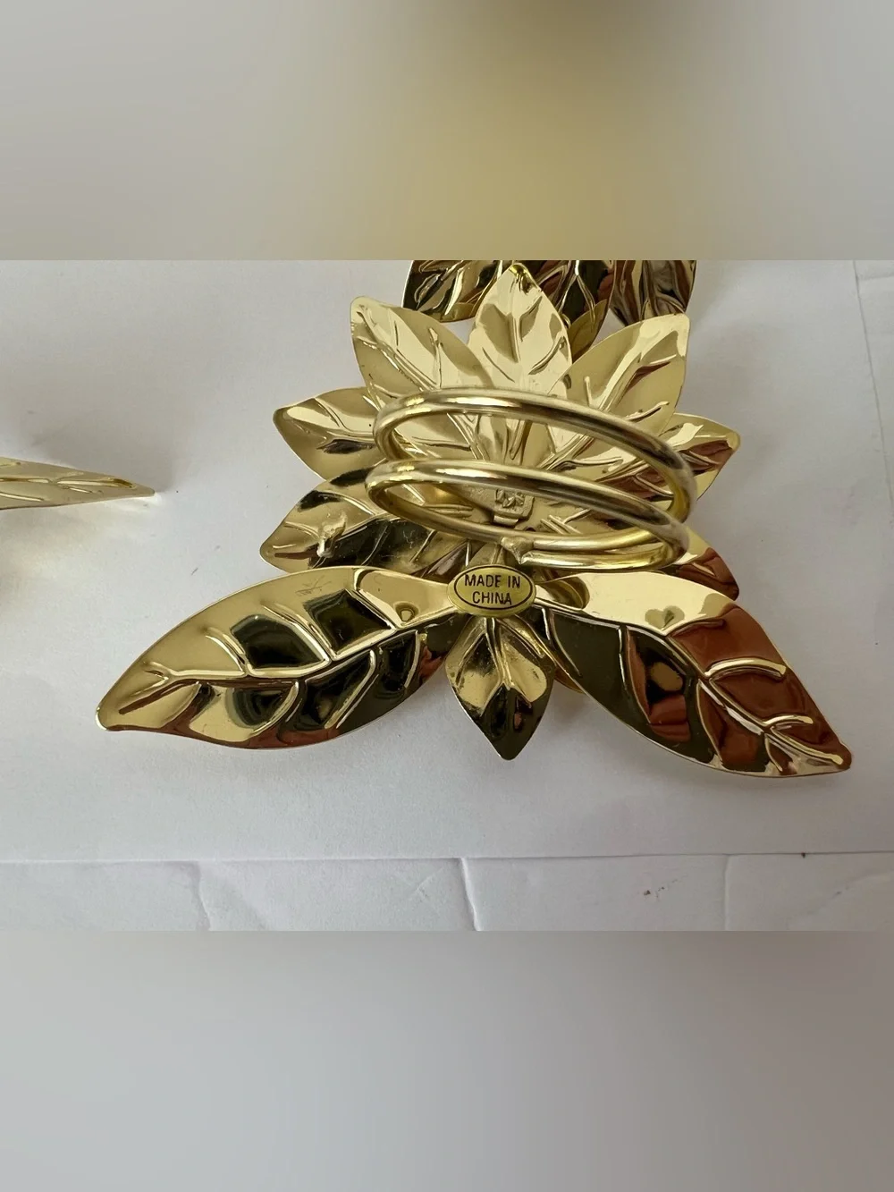 Pre-owned, barely used, gold-tone Poinsettia Napkin Rings -Set of 7